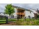 Exterior view of the home with a beautiful wooden fence and a covered deck overlooking the lush greenery, perfect for relaxation at 4380 Serenity Lake Dr, Cumming, GA 30028