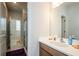A bright bathroom featuring a vanity with a sink and a glass enclosed shower at 4380 Serenity Lake Dr, Cumming, GA 30028