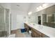 Luxurious bathroom featuring double sinks, tiled floor, a glass-enclosed shower, and modern fixtures at 4380 Serenity Lake Dr, Cumming, GA 30028
