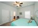 Comfortable bedroom with a ceiling fan, a large window and an attached bathroom at 4380 Serenity Lake Dr, Cumming, GA 30028