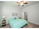 Comfortable bedroom with a ceiling fan, a large window and a bedside table lamp at 4380 Serenity Lake Dr, Cumming, GA 30028