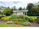 Landscaped community entrance with a pergola covered sign that reads 'Lake Haven' surrounded by colorful plants at 4380 Serenity Lake Dr, Cumming, GA 30028