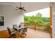 View from the deck showing an outdoor dining table and seating overlooking a green lawn at 4380 Serenity Lake Dr, Cumming, GA 30028