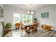 Bright dining room with hardwood floors, large windows and great natural light for entertaining and Gathering meals at 4380 Serenity Lake Dr, Cumming, GA 30028