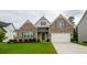 Charming brick home with a two-car garage and well-manicured front lawn at 4380 Serenity Lake Dr, Cumming, GA 30028