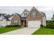 Attractive two-story brick home with a spacious driveway and manicured lawn at 4380 Serenity Lake Dr, Cumming, GA 30028