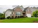 Charming brick home with a manicured lawn and lush landscaping at 4380 Serenity Lake Dr, Cumming, GA 30028