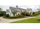 Charming home exterior with manicured landscaping, a stone chimney, and a well-designed walkway at 4380 Serenity Lake Dr, Cumming, GA 30028