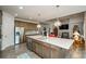 Spacious kitchen with stainless appliances, a large island, and an open layout leading to the living room at 4380 Serenity Lake Dr, Cumming, GA 30028