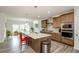 Well-lit kitchen with a large island, stainless steel appliances, wooden cabinets, and a casual dining area at 4380 Serenity Lake Dr, Cumming, GA 30028