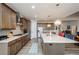 A modern kitchen with stainless appliances, beautiful cabinets and a large island is open to the living area at 4380 Serenity Lake Dr, Cumming, GA 30028