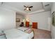 Bright main bedroom showcasing a tray ceiling, carpeted floors, a wooden bed frame, and neutral paint at 4380 Serenity Lake Dr, Cumming, GA 30028