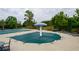 The community pool is covered for the winter, and is surrounded by trees and chairs at 4380 Serenity Lake Dr, Cumming, GA 30028