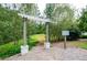 Welcoming entrance to the Lake Haven trail, marked by a charming pergola and clear signage in a natural setting at 4380 Serenity Lake Dr, Cumming, GA 30028