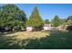 Large backyard with firepit and mature trees at 1022 Washington Ave, Woodstock, GA 30188