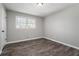 Simple bedroom with wood-look floors and neutral walls at 1022 Washington Ave, Woodstock, GA 30188