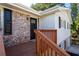Charming front entrance with a brick facade, wooden deck, and black door at 1022 Washington Ave, Woodstock, GA 30188