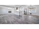 Modern kitchen with stainless steel appliances, an island, and grey wood-look floors at 1022 Washington Ave, Woodstock, GA 30188