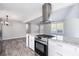 Updated kitchen featuring granite countertops and stainless steel range at 1022 Washington Ave, Woodstock, GA 30188