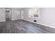 Open living area with grey wood-look floors and neutral wall colors at 1022 Washington Ave, Woodstock, GA 30188