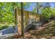 Expansive backyard featuring a two-story home with a wooden deck and a serene, wooded setting at 3500 Quinn Ridge Dr, Snellville, GA 30039