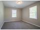 Bright carpeted bedroom with neutral walls and two large windows at 3500 Quinn Ridge Dr, Snellville, GA 30039