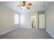 Large bedroom with ensuite bath, neutral walls, plush carpet, and ceiling fan at 3500 Quinn Ridge Dr, Snellville, GA 30039