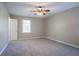 Bright bedroom with neutral walls, plush carpet, ceiling fan, and a large window at 3500 Quinn Ridge Dr, Snellville, GA 30039