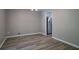 Neutral dining room featuring laminate flooring and an overhead light fixture, adjacent to kitchen at 3500 Quinn Ridge Dr, Snellville, GA 30039