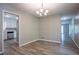 Inviting dining area with modern chandelier and laminate flooring, leading to an open kitchen at 3500 Quinn Ridge Dr, Snellville, GA 30039