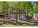 Charming home boasts a welcoming front porch with white railings, surrounded by mature trees and a lush yard at 3500 Quinn Ridge Dr, Snellville, GA 30039
