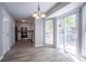 Bright kitchen featuring stainless appliances, white cabinets, and modern chandelier with sliding glass doors to the outside at 3500 Quinn Ridge Dr, Snellville, GA 30039