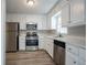 Bright kitchen featuring stainless steel appliances, white cabinets, and ample counter space at 3500 Quinn Ridge Dr, Snellville, GA 30039