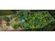 Aerial view showing house and surrounding wooded area at 915 Rocky Creek Rd, Hampton, GA 30228