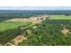 Aerial view showing a large property with expansive green fields and woodland at 915 Rocky Creek Rd, Hampton, GA 30228