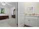 Bathroom with vanity, mirror, and view of bedroom at 915 Rocky Creek Rd, Hampton, GA 30228