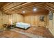Rustic bedroom with wood walls and concrete floors at 915 Rocky Creek Rd, Hampton, GA 30228