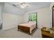 Bright bedroom with a wooden bed frame and carpeted floor at 915 Rocky Creek Rd, Hampton, GA 30228