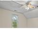 Bright bonus room featuring a ceiling fan and window at 915 Rocky Creek Rd, Hampton, GA 30228