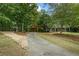 Long driveway leading to a charming house with a covered carport at 915 Rocky Creek Rd, Hampton, GA 30228