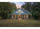 Two-story home with a green metal roof and a large front porch at 915 Rocky Creek Rd, Hampton, GA 30228