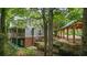 House exterior showcasing a deck, brick foundation, and wooded views at 915 Rocky Creek Rd, Hampton, GA 30228