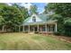 Charming house exterior with a metal roof and large front porch at 915 Rocky Creek Rd, Hampton, GA 30228