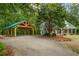 Gray house exterior with a covered carport and lush green surroundings at 915 Rocky Creek Rd, Hampton, GA 30228