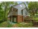 House exterior with a deck, brick foundation, and terraced landscaping at 915 Rocky Creek Rd, Hampton, GA 30228