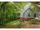 Gray house exterior with deck, nestled in a wooded setting at 915 Rocky Creek Road Rd, Hampton, GA 30228