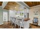 Renovated kitchen with white cabinets, butcher block island, and wood ceiling at 915 Rocky Creek Rd, Hampton, GA 30228