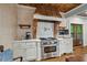 Kitchen with copper hood, white cabinets, and stainless steel range at 915 Rocky Creek Rd, Hampton, GA 30228