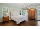 Spacious main bedroom with hardwood floors and antique armoire at 915 Rocky Creek Rd, Hampton, GA 30228