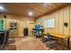 Rustic home office with wood walls, desk, and comfortable seating at 915 Rocky Creek Rd, Hampton, GA 30228